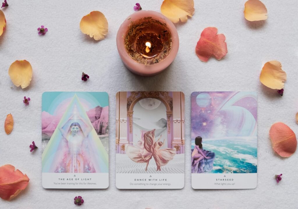 This image shows a 3 card oracle card spread and candle, a moment of mindful self reflection.